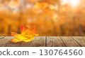 colorful fall leaf on wooden floor, autumn natural background of forest with maple trees 130764560