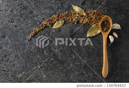 Mix of organic dried spices on a black stone background. Mix of organic dried spices on a black stone background. 130764837