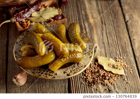 Pickled cucumbers with ingredients on an old wooden table. Pickled cucumbers with ingredients on an old wooden table. 130764839