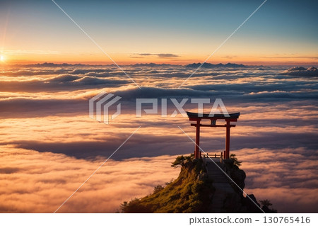 A magnificent view of the shrine's torii gate and the rising sun floating in a golden sea of clouds 130765416