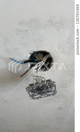 Danger of exposed electrical wires in wall socket box. Close up of bare copper cables with insulation removed. Risk of electric shock, unsafe installation, hazard warning, electricity and power repair Danger of exposed electrical wires in wall socket box. Close up of bare copper cables with insulation removed. Risk of electric shock, unsafe installation, hazard warning, electricity and power repair 130765468