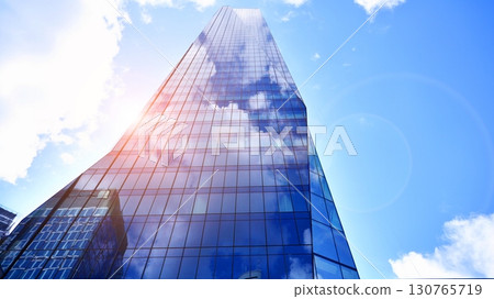 Modern sustainable glass office buildings. Exterior view of corporate headquarters glass buildings architecture.Glass windows in energy-efficient buildings. Financial business center buildings.  130765719