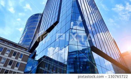 Modern sustainable glass office buildings. Exterior view of corporate headquarters glass buildings architecture.Glass windows in energy-efficient buildings. Financial business center buildings. Modern sustainable glass office buildings. Exterior view of corporate headquarters glass buildings architecture.Glass windows in energy-efficient buildings. Financial business center buildings. 130765722