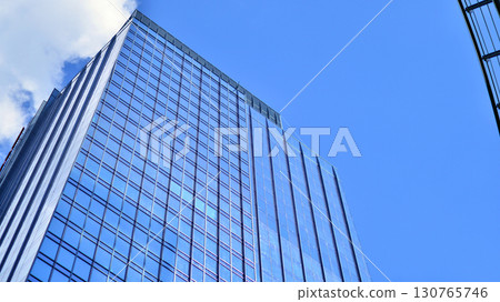 Modern sustainable glass office buildings. Exterior view of corporate headquarters glass buildings architecture.Glass windows in energy-efficient buildings. Financial business center buildings.  130765746