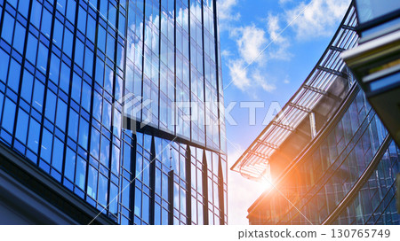 Modern sustainable glass office buildings. Exterior view of corporate headquarters glass buildings architecture.Glass windows in energy-efficient buildings. Financial business center buildings.  130765749