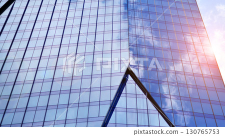 Modern sustainable glass office buildings. Exterior view of corporate headquarters glass buildings architecture.Glass windows in energy-efficient buildings. Financial business center buildings.  130765753
