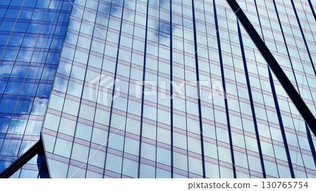 Modern sustainable glass office buildings. Exterior view of corporate headquarters glass buildings architecture.Glass windows in energy-efficient buildings. Financial business center buildings. Modern sustainable glass office buildings. Exterior view of corporate headquarters glass buildings architecture.Glass windows in energy-efficient buildings. Financial business center buildings. 130765754