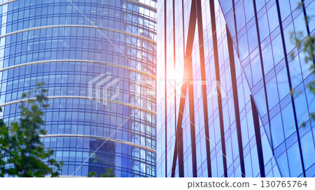 Modern sustainable glass office buildings. Exterior view of corporate headquarters glass buildings architecture.Glass windows in energy-efficient buildings. Financial business center buildings. Modern sustainable glass office buildings. Exterior view of corporate headquarters glass buildings architecture.Glass windows in energy-efficient buildings. Financial business center buildings. 130765764