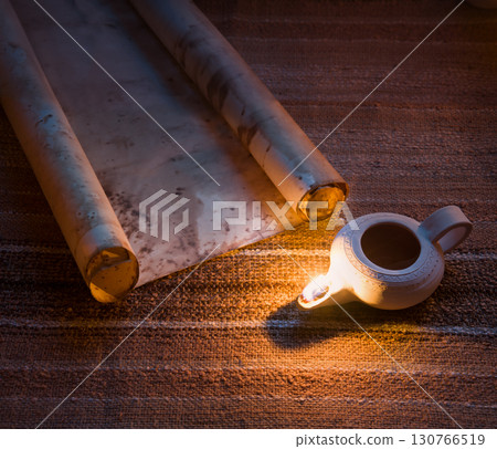 Old oil lamp and scroll 130766519