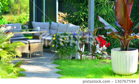 Modern aluminum pergola with stylish garden furniture in a beautiful garden. Modern aluminum pergola with stylish garden furniture in a beautiful garden. 130767594