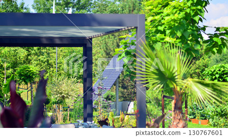 Modern aluminum pergola with stylish garden furniture in a beautiful garden. Modern aluminum pergola with stylish garden furniture in a beautiful garden. 130767601