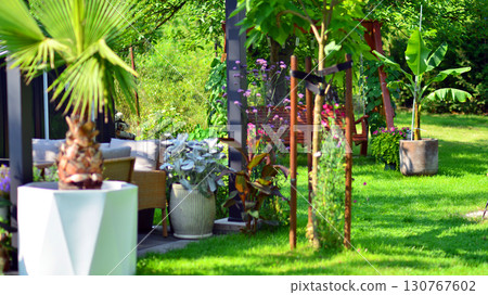 Modern aluminum pergola with stylish garden furniture in a beautiful garden. Modern aluminum pergola with stylish garden furniture in a beautiful garden. 130767602