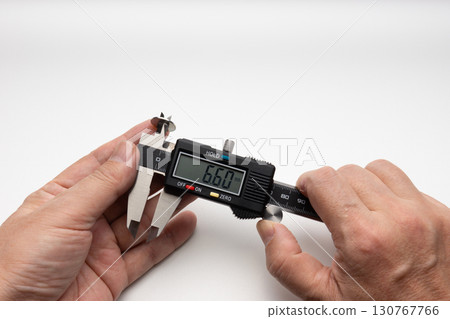 Measuring the inner diameter of a washer with a digital caliper and using both hands Measuring the inner diameter of a washer with a digital caliper and using both hands 130767766