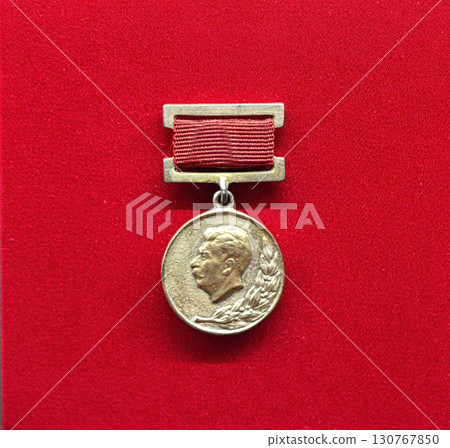 Soviet medal featuring Stalin profile on red background 130767850