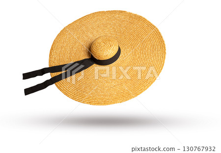 Large straw hat with black ribbon floating on white background 130767932