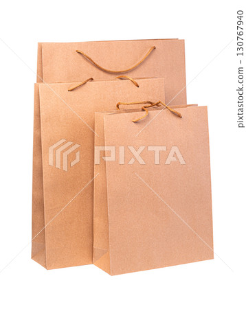 Three brown paper shopping bags with transparent background 130767940