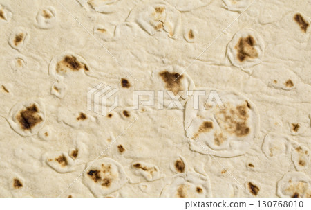 Close-up of lavash texture showing bubbles and charred spots 130768010