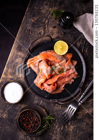 Salted sliced salmon fish with herbs 130768235