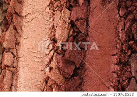 Broken and smashed make-up eyeshadow pallete, lay of brush strokes, close-up for background, top view. Sample cosmetics concept 130768538
