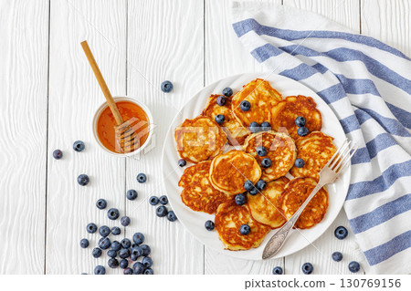 fried hot and crispy pancakes with blueberries 130769156