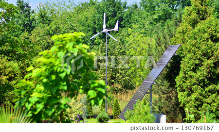 Solar panels with wind turbine on blue sky. Concept of clean energy. Green technology for future. Solar panels with wind turbine on blue sky. Concept of clean energy. Green technology for future. 130769167