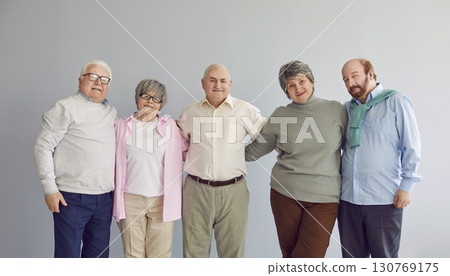 Group portrait of happy senior retired men and women standing together and hugging Group portrait of happy senior retired men and women standing together and hugging 130769175