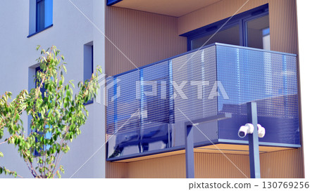 Modern apartment building with balconies and greenery. Beautiful view of real estate buildings in summer. Walking area with trees and grass. Modern residential buildings in the public green area. Modern apartment building with balconies and greenery. Beautiful view of real estate buildings in summer. Walking area with trees and grass. Modern residential buildings in the public green area. 130769256