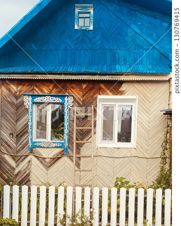 A small wooden house in a rustic style in bright blue and beige colors representing village life and home renovation A small wooden house in a rustic style in bright blue and beige colors representing village life and home renovation 130769415