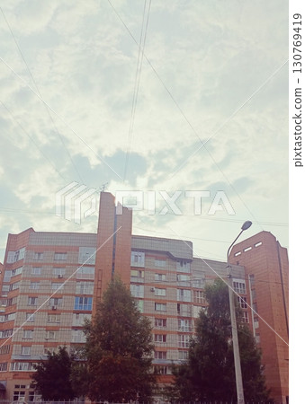 Multi-story block building in a brutalist style in muted colors representing post-soviet architecture Multi-story block building in a brutalist style in muted colors representing post-soviet architecture 130769419