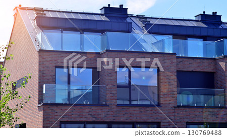 Harmony with nature, eco architecture. Terraced single family homes in newly developed housing estate. The real estate market in the suburbs with lush greenery surrounding.  130769488