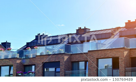 Harmony with nature, eco architecture. Terraced single family homes in newly developed housing estate. The real estate market in the suburbs with lush greenery surrounding.  130769489