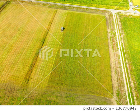 Aerial shot of grass cutting in Esashi Town, Hokkaido in early autumn 130770942