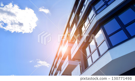 Modern apartment buildings on a sunny day with a blue sky. Facade of a modern apartment building. Modern residential apartment building complex condo. Modern apartment buildings on a sunny day with a blue sky. Facade of a modern apartment building. Modern residential apartment building complex condo. 130771498