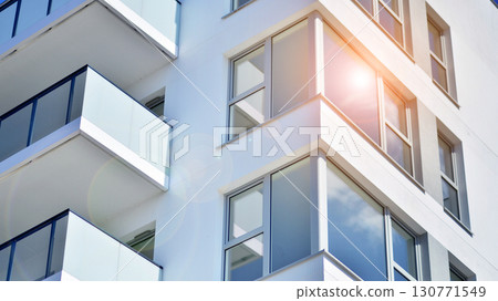 Modern apartment buildings on a sunny day with a blue sky. Facade of a modern apartment building. Modern residential apartment building complex condo. Modern apartment buildings on a sunny day with a blue sky. Facade of a modern apartment building. Modern residential apartment building complex condo. 130771549