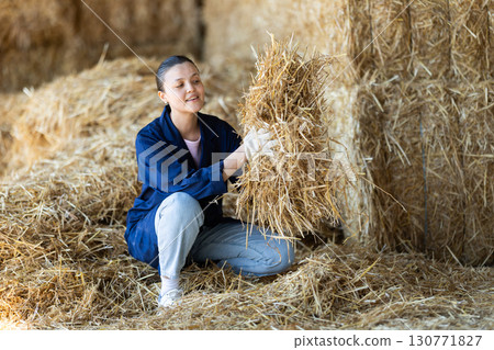 Asian female worker inspect straw in storage 130771827