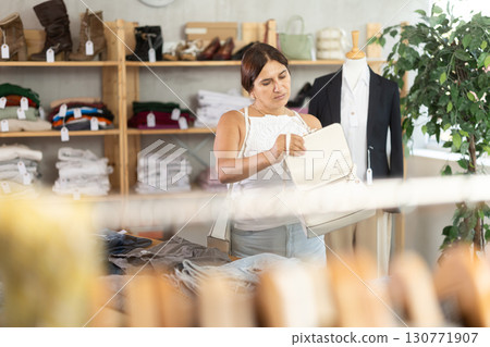 Woman view assortment in clothing department, buying lady handbag 130771907
