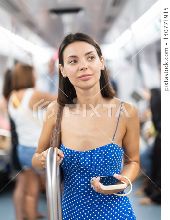 Young girl standing in wagon holding phone in hand Young girl standing in wagon holding phone in hand 130771915