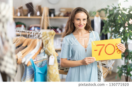 Woman holding poster with 70 percent discount 130771920