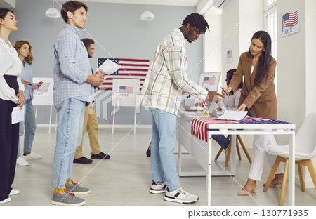 African American male voter signs during registration at polling place on Election Day in USA. 130771935