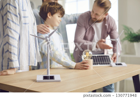 Family discussing sustainable renewable energy sources. 130771948