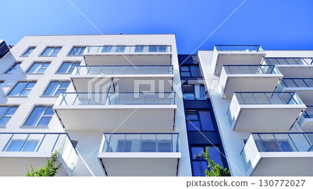 Architectural details of modern apartment building. Modern european residential apartment building complex. Architectural details of modern apartment building. Modern european residential apartment building complex. 130772027