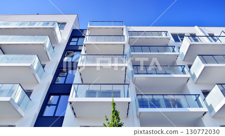 Architectural details of modern apartment building. Modern european residential apartment building complex. Architectural details of modern apartment building. Modern european residential apartment building complex. 130772030