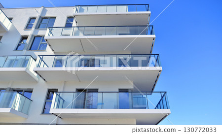 Architectural details of modern apartment building. Modern european residential apartment building complex. Architectural details of modern apartment building. Modern european residential apartment building complex. 130772033