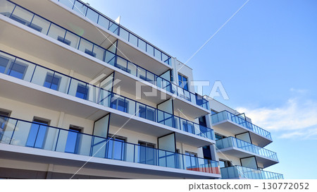 Architectural details of modern apartment building. Modern european residential apartment building complex. Architectural details of modern apartment building. Modern european residential apartment building complex. 130772052