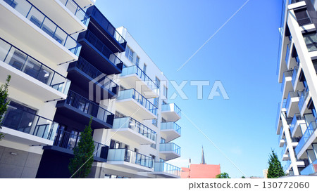 Architectural details of modern apartment building. Modern european residential apartment building complex. Architectural details of modern apartment building. Modern european residential apartment building complex. 130772060