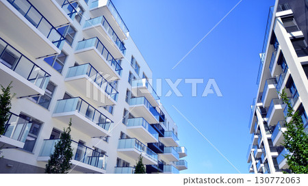 Architectural details of modern apartment building. Modern european residential apartment building complex. Architectural details of modern apartment building. Modern european residential apartment building complex. 130772063