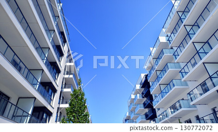 Architectural details of modern apartment building. Modern european residential apartment building complex. Architectural details of modern apartment building. Modern european residential apartment building complex. 130772072