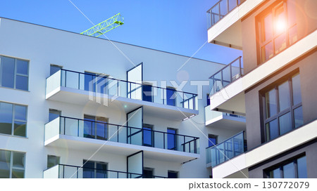 Architectural details of modern apartment building. Modern european residential apartment building complex. Architectural details of modern apartment building. Modern european residential apartment building complex. 130772079