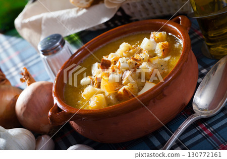 Vegetable soup with croutons and cheese in a clay plate Vegetable soup with croutons and cheese in a clay plate 130772161