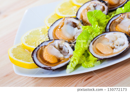 Raw bivalve shellfishes with lemon 130772173